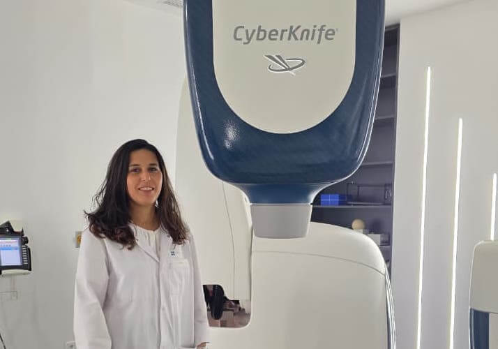 Dr Sara Ridai devant le CyberKnife - radiochirurgie de précision